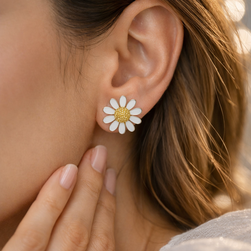 Close-up of a person wearing a daisy flower earring with a blurred background